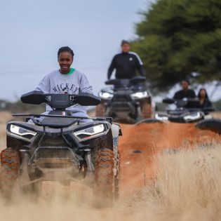 a group of people enjoying the quad bikes at nelo's farmyard and adventure on the custom made obstacle course